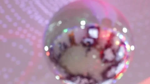 Shiny mirror ball spinning under ceiling with illumination, variable focus Stock Footage 276363014