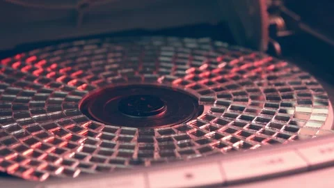 Shiny mosaic CD spins in open player tray, evoking nostalgic vibes of 90s tech, Video stock 305573910