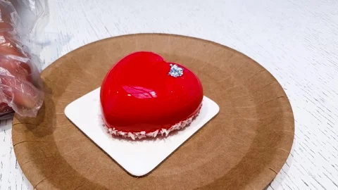 A shiny mousse cake shape heart. Romantic mousse dessert cake shape of a heart. Stock Footage 314073353