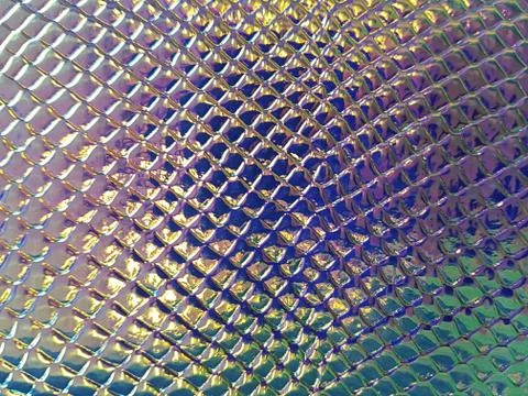 A shiny neon colored surface with many small cells of different sizes. Concept Stock Photos