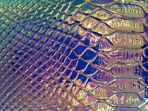 A shiny neon colored surface with many small cells of different sizes. Concep Stock Photos