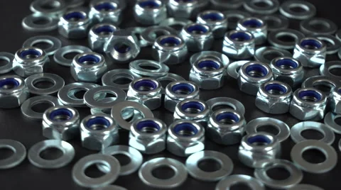 Shiny nuts and washers rotating on a black background. Seamless loop. Prores 4K Stock Footage 66856406