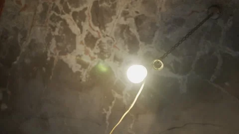 Shiny old light bulb in the dark 4K video Stock Footage 143505854