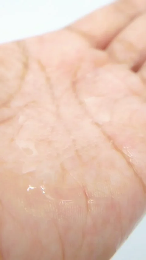 Shiny palm with clear liquid on hand. Skin cleansing soap liquid. Close up .. Stock Footage 335022418