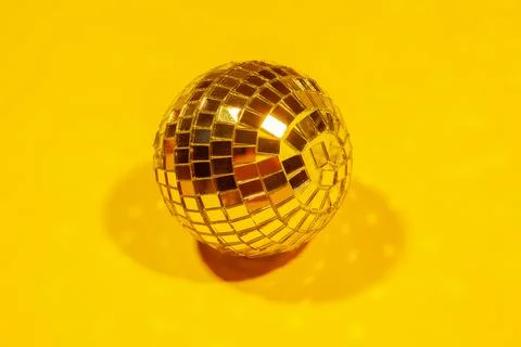 Shiny party disco balls shining in a day light over color background Stock Photos