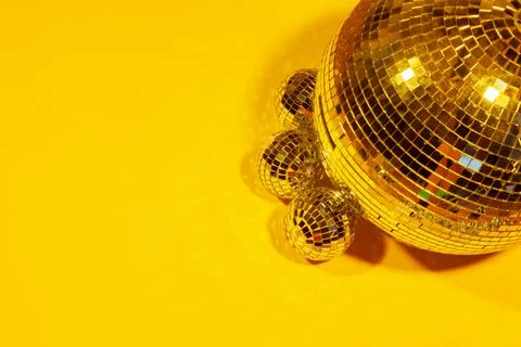 Shiny party disco balls shining in a day light over color background Stock Photos