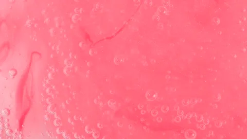 Shiny pink gel fluid with bubbles, rotating. Macro texture of cosmetics produ Stock Footage 276484681
