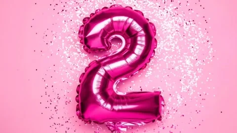 Shiny Pink Number Two Balloon with Glitter on Pink Background - Celebration Stock Footage 333410485