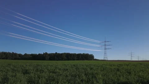 Shiny power cables between high-voltage towers against the clear blue sky Stock Footage 344797026