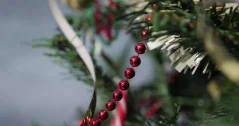 Shiny red pearls string on Christmas tree 4K footage Stock Footage 298828461