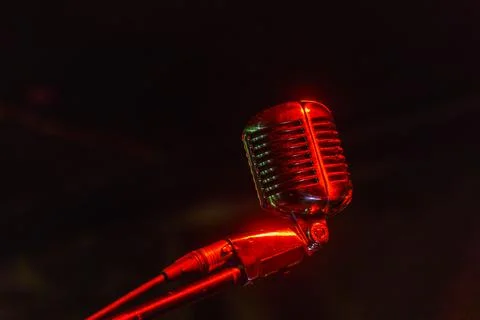 Shiny retro microphone on black background Stock Photos