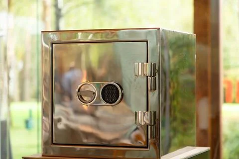 Shiny safe that reflects the fire, with a combination lock Stock Photos