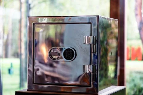 Shiny safe that reflects the fire, with a combination lock Stock Photos