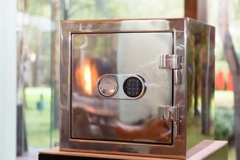 Shiny safe that reflects the fire, with a combination lock Stock Photos