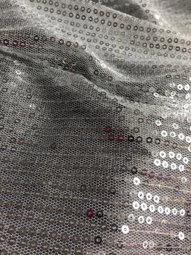 Shiny silver sequin fabric with decorative circles Stock Photos