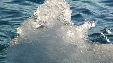 Shiny small iceberg from the shore Stock Footage 37913402
