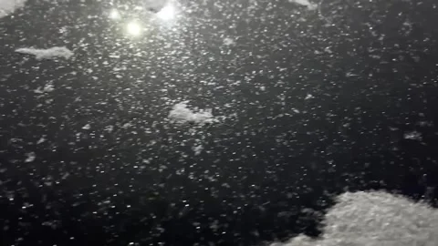 Shiny snow sparkles in light on a dark background. Stock Footage 262577581