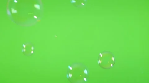 Shiny soap bubbles  flying from left to right in front of green screen backgr Stock Footage 50908365