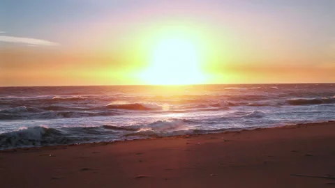 Shiny sun coming up to the sky in front of the beach Stock Footage 232909497