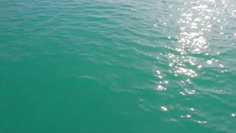 Shiny sun glare reflection on deep blue sea water surface n cyan ocean wave Stock Footage 148089776