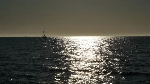Shiny sun reflections. Sparkling sea water. Ocean waves. Sailboat. Real time. Stock Footage 155332505