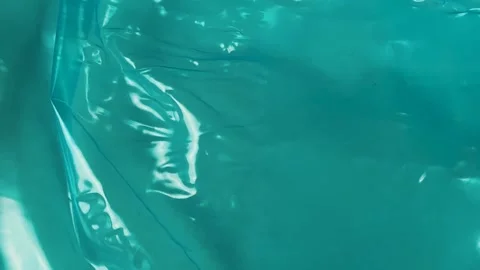 Shiny teal plastic wrap texture background 스톡 동영상 340581351