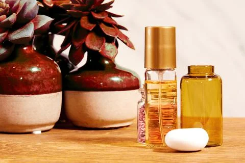 Shiny tiny bottles with perfume and oil and decorative plants Stock Photos