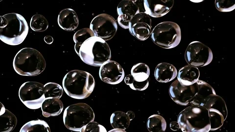 Shiny transparent bubbles floating in slow motion against black background. Stock Footage 342421274
