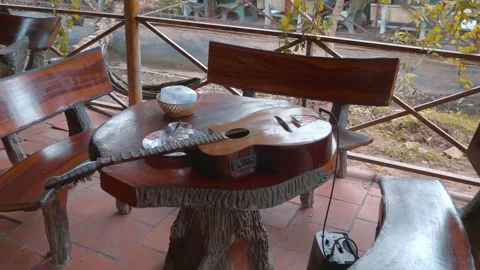 Shiny well polished table and benches with electric guitar and speaker Video stock 333328691