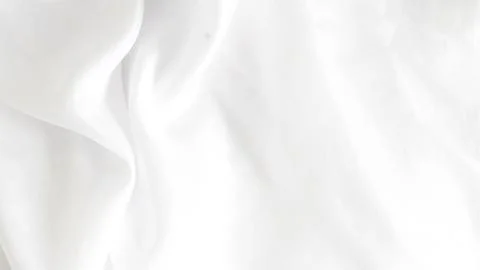 Shiny white silk fabric reflecting soft light, creating a rich texture. Stock Photos
