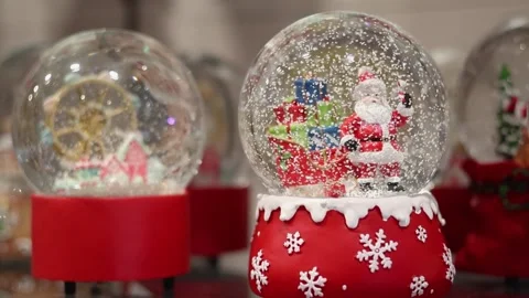 Shiny winter snow globe with Santa Claus inside. Closeup. Slow motion Stock Footage 289474249