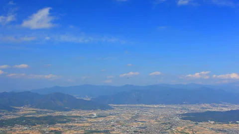 Shioda Plain and the Overlook of Ueda City with Flowing Clouds Stockbeeldmateriaal 330610599