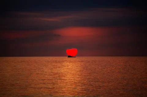 Ship against the backdrop of the setting sun Stock Photos