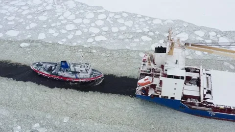 Ship and boat sail through frozen fairway , aerial view Stock Footage 170385385