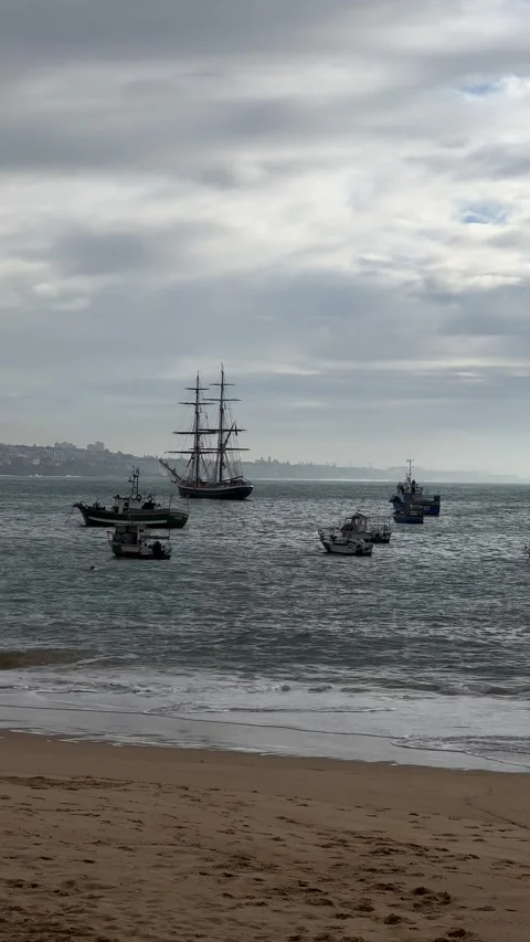 Ship and boats in ocean. View from beach in Cascais, Portugal. Vertical Stock Footage 241023738