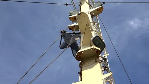 Ship antenna round radar hangs on rope at steel tower Stock Footage 113455219