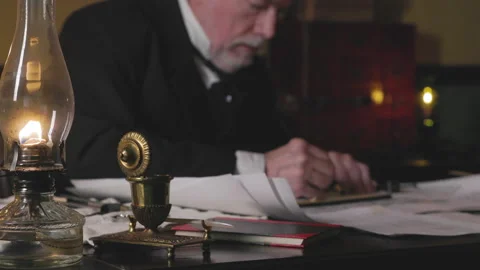 Ship architect using graphite pencil and other tools focus on oil lamp Stock Footage 336746717