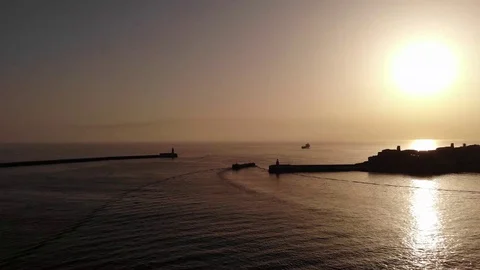 Ship Arrival on calm see during sunrise to the Grand Harbour Stock Footage