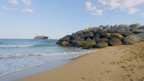 Ship in the background from the jetty at a beach Stock Footage 94668940