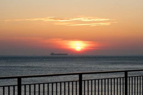 Ship on the background of an orange sunset Stock Photos