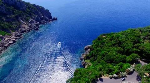 Ship boat sailing Paleokastritsa bay Greece Corfu aerial 4k video Gulf ocean sea Stock Footage