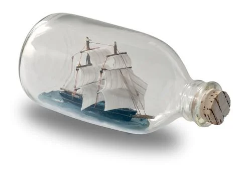 Ship in a Bottle. Small ship model in a bottle with a cork stopper Stock Photos