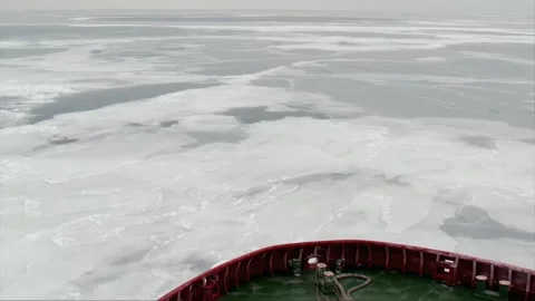 Ship bow breaking ice in frozen sea during cold winter day Video stock 313546771