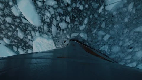 Ship bow cuts through dense drifting sea ice in remote Arctic waters of Stock Footage 344230753