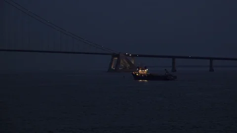 Ship with bright flashlights sails in direction to bridge Stock Footage 113093844