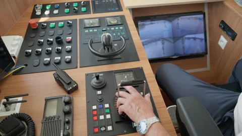 Ship captain operates throttle lever on control console to steer riverboat Vídeo Stock 342321143