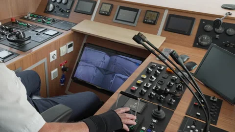 Ship captain operating bridge controls and steering console during navigation Stock Footage 342336507