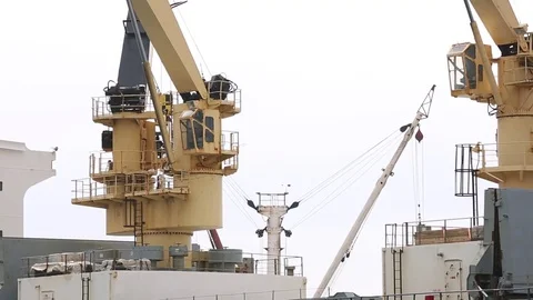 Ship cranes loading cargo Stock Footage 77047863