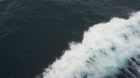 Ship creates waves and white bubbles on her sides Stock Footage 235812388