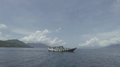 A ship crossing the Larantuka strait Stock Footage 187368608